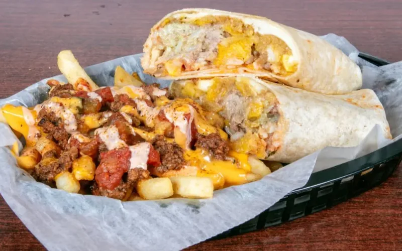 Mofongo burrito cut in half with loaded fries