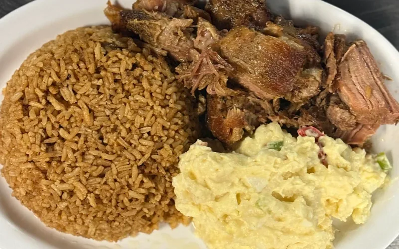 Pernil plate with Spanish yellow rice and potato salad